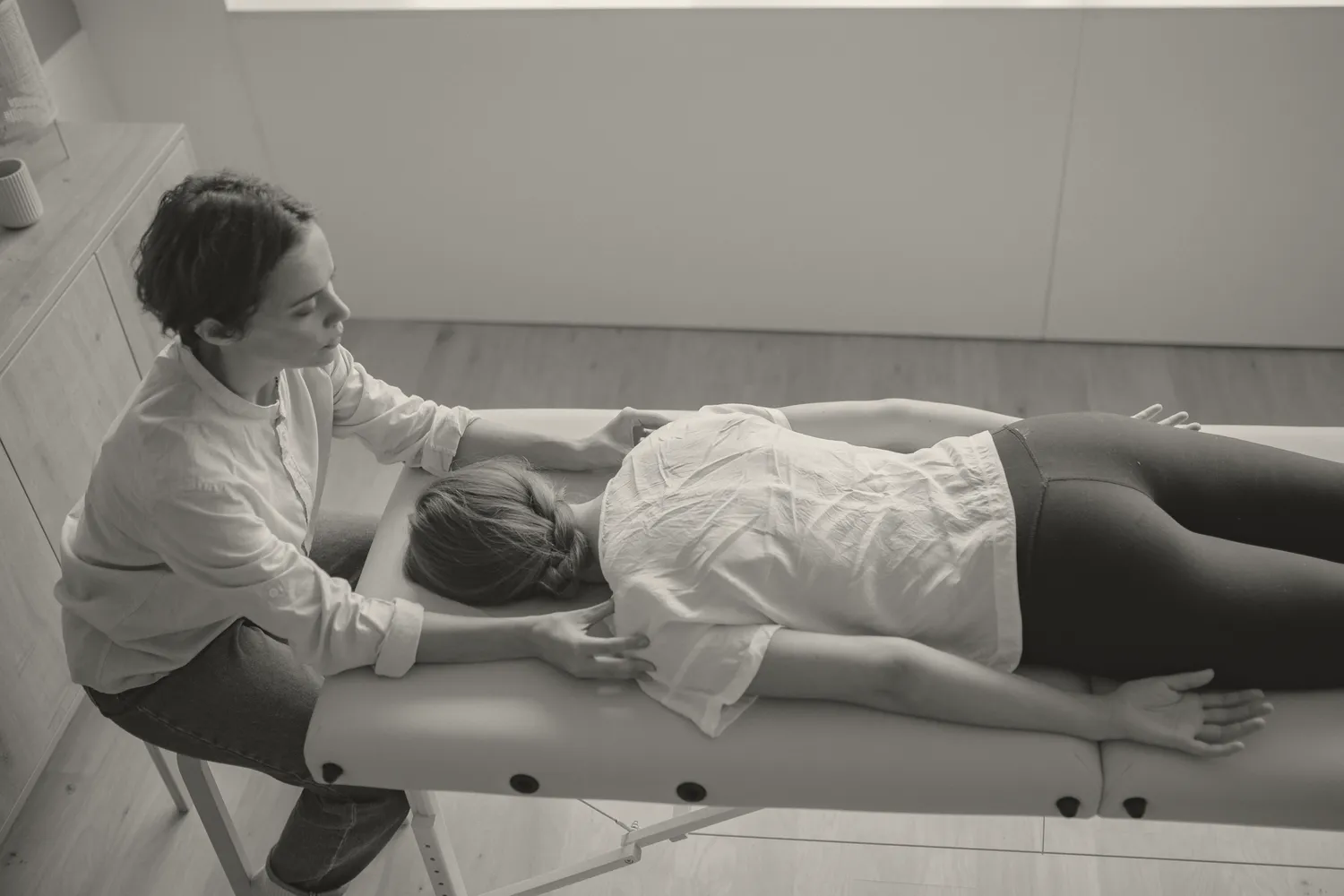 A chiropractic treatment room with a patient on the table